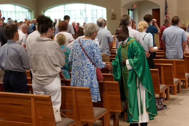 Fr. Patrick greeting parishioners after Mass