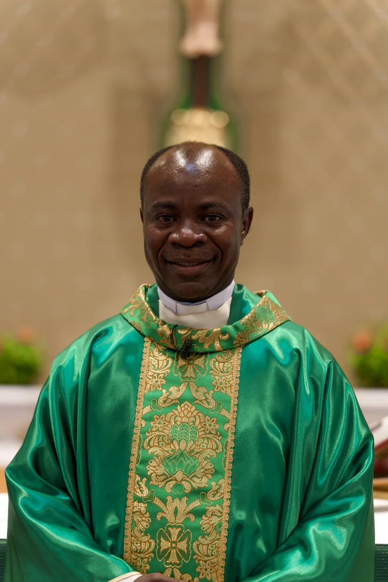Fr. Patrick Kizza in green vestments